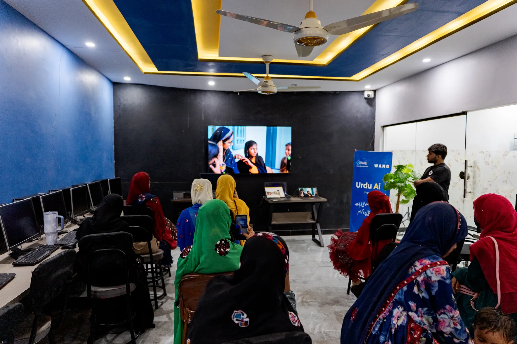 Women participating in an Urdu AI learning session at WALI